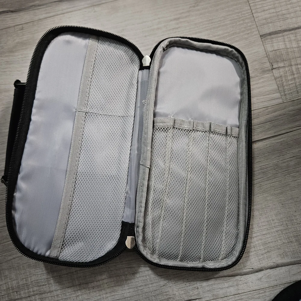 Torfly pencil case. Black with 2 zipper pouches and handle. Torly logo on front.